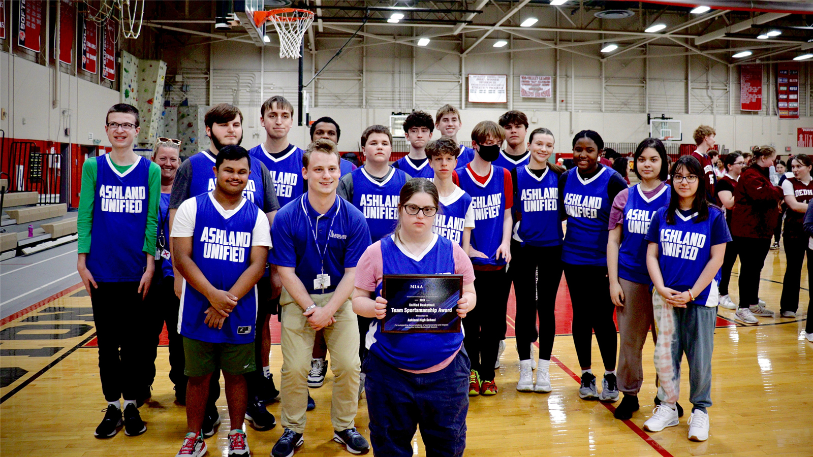  The 2024 Unified Basketball team and coaches with their award plaque.